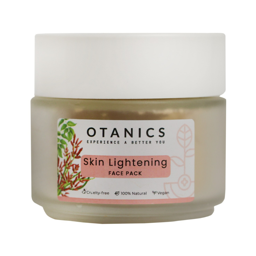 Image of Otanics Skin Lightening Face Pack jar with a white lid and a clear label. The label reads 'Otanics Skin Lightening Face Pack' with a soft pink background and botanical illustrations. The jar is labeled as cruelty-free, 100% natural, and vegan. The jar is placed on a plain background, showcasing the product packaging.