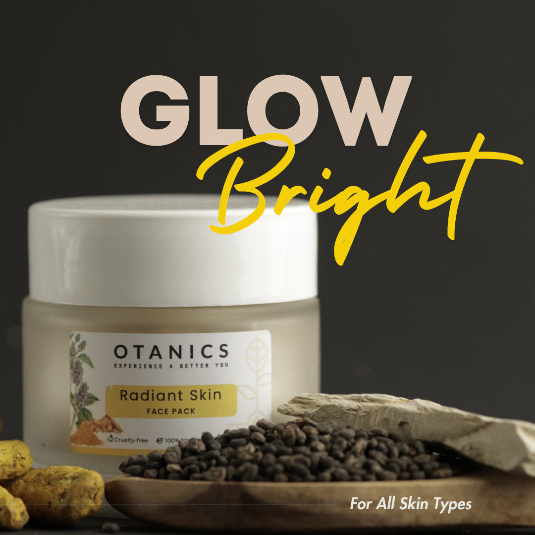 Image of Otanics Radiant Skin Face Pack jar with a white lid and a clear label. The label reads 'Otanics Radiant Skin Face Pack' with a yellow background and botanical illustrations. The jar is placed on a textured surface, surrounded by natural elements like turmeric and herbs. The bold text 'GLOW Bright' is displayed above, and the label indicates the product is suitable for all skin types, cruelty-free, 100% natural, and vegan.